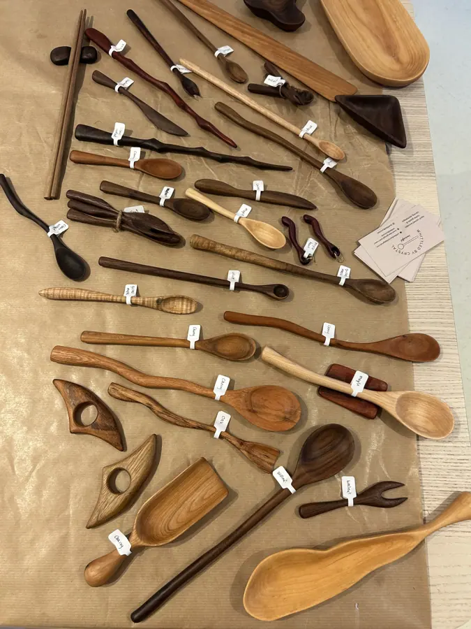 rows of hand-carved wooden spoons laid out and labelled