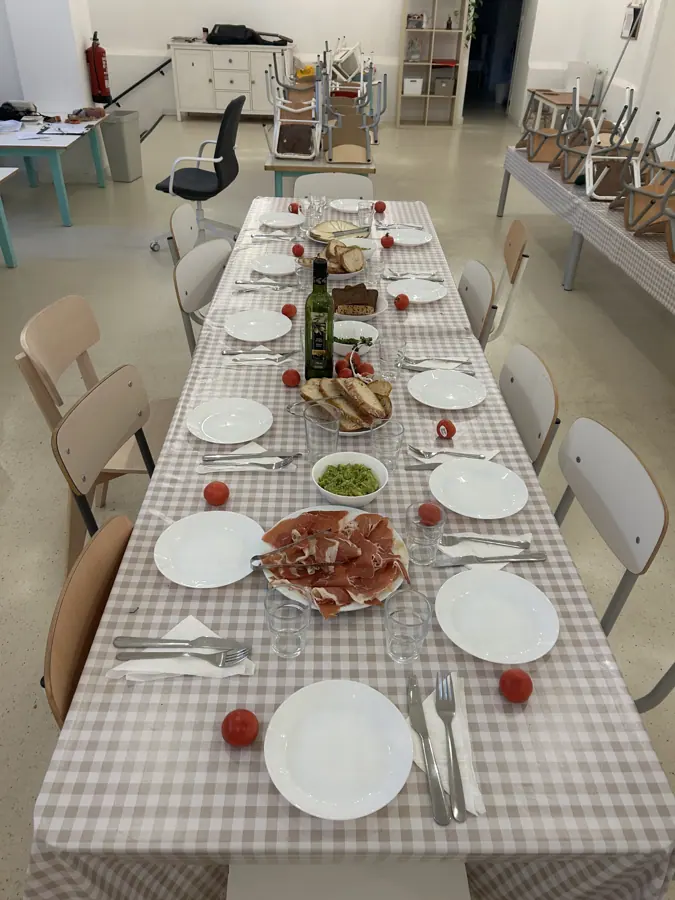 a long table laid with cloth and plates before a meal