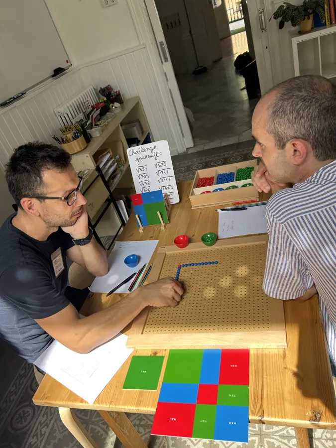 two participants talking across a table spread with materials