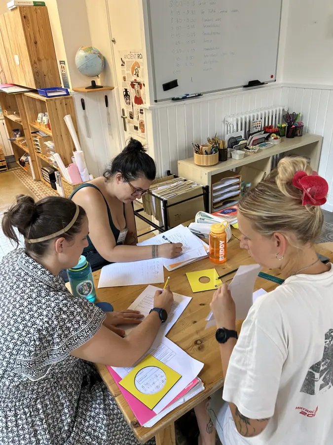 four participants working together over materials at a table