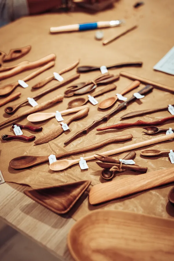 rows of hand-carved wooden spoons laid out and labelled